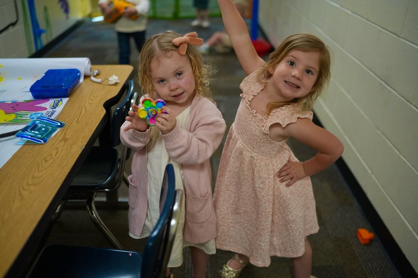 Two young children playing at a table during Valley Kids Club on a Sunday morning