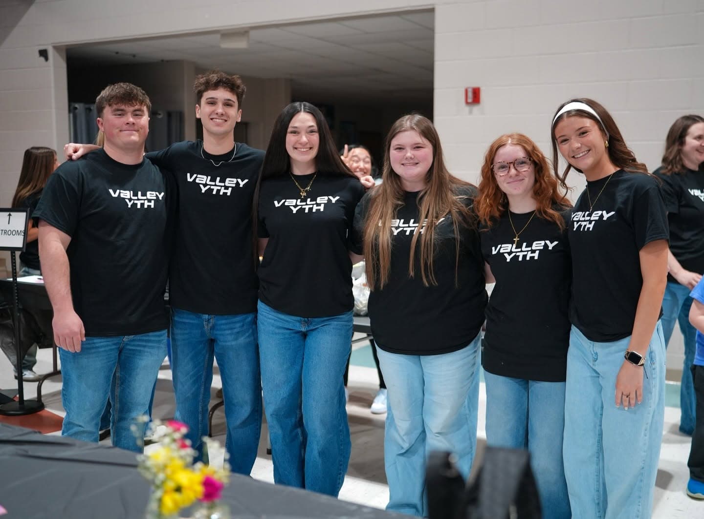 Students in Valley Youth shirts together at a Wednesday night gathering